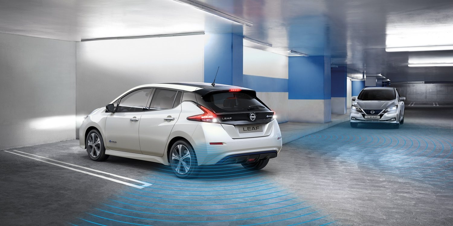 Nissan LEAF in a garage showing Rear Cross Traffic Alert detecting a vehicle coming towards it
