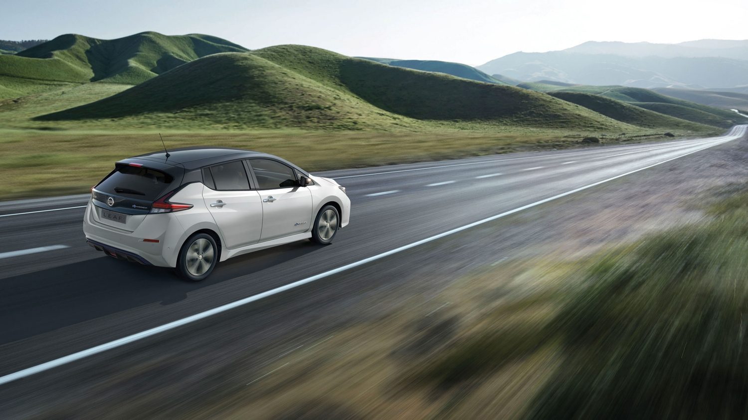 Nissan LEAF shown from the rear driving on a highway