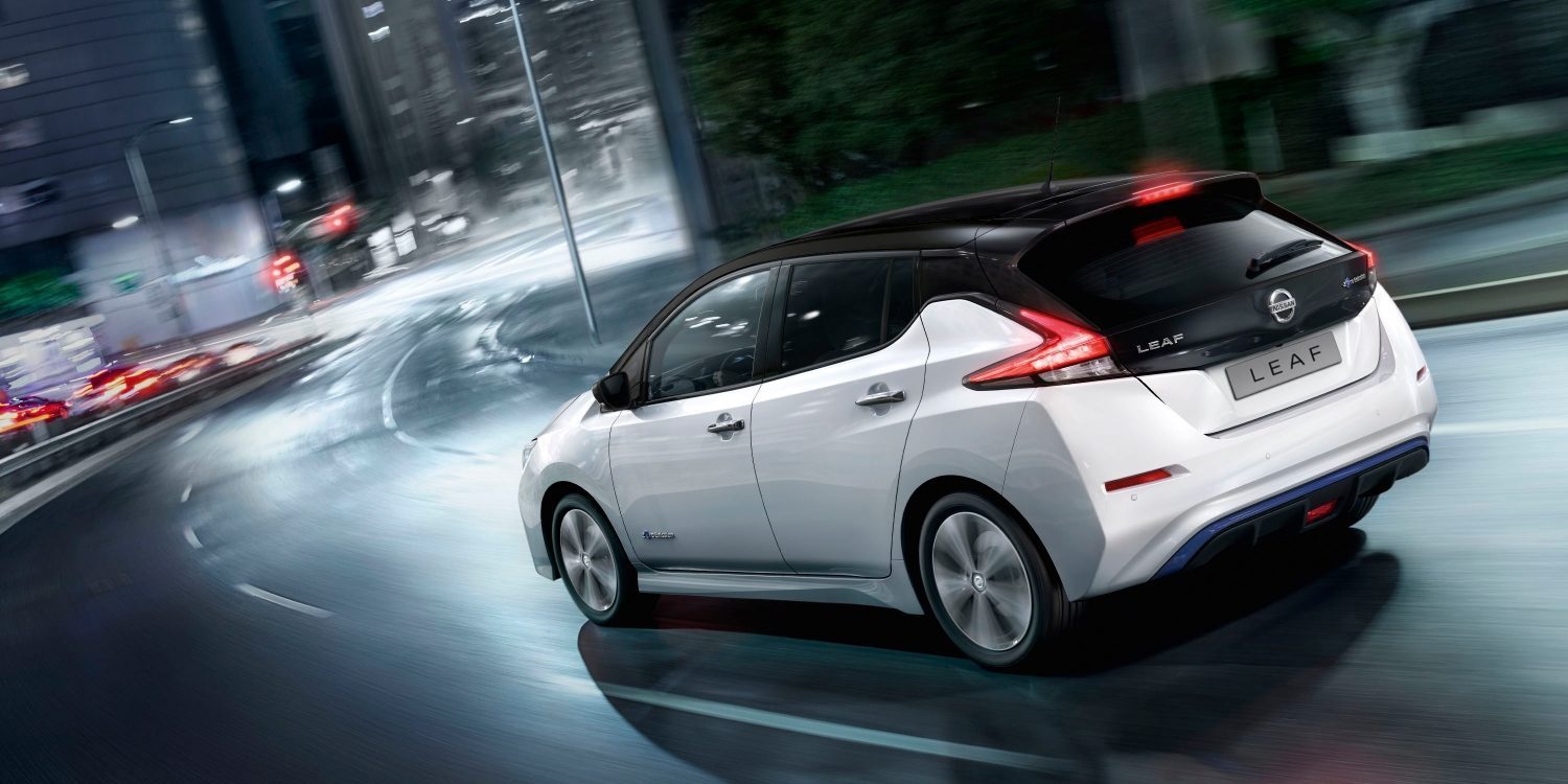 Nissan LEAF driving on a bridge with battery and motor showing