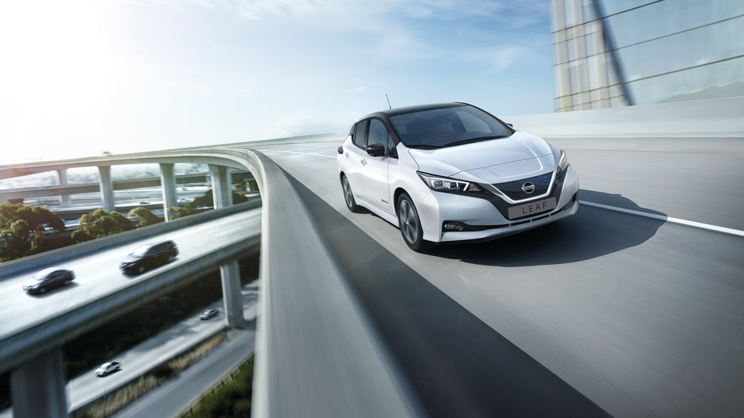 Nissan LEAF shown from the front driving on a highway overpass