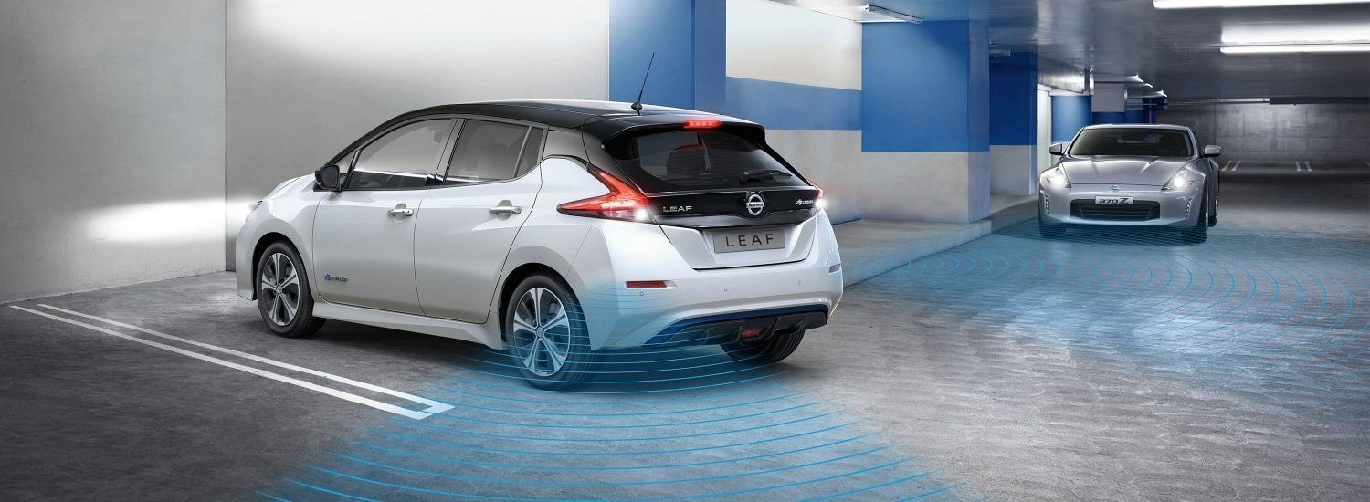 Nissan LEAF in a garage showing Rear Cross Traffic Alert detecting a vehicle coming towards it