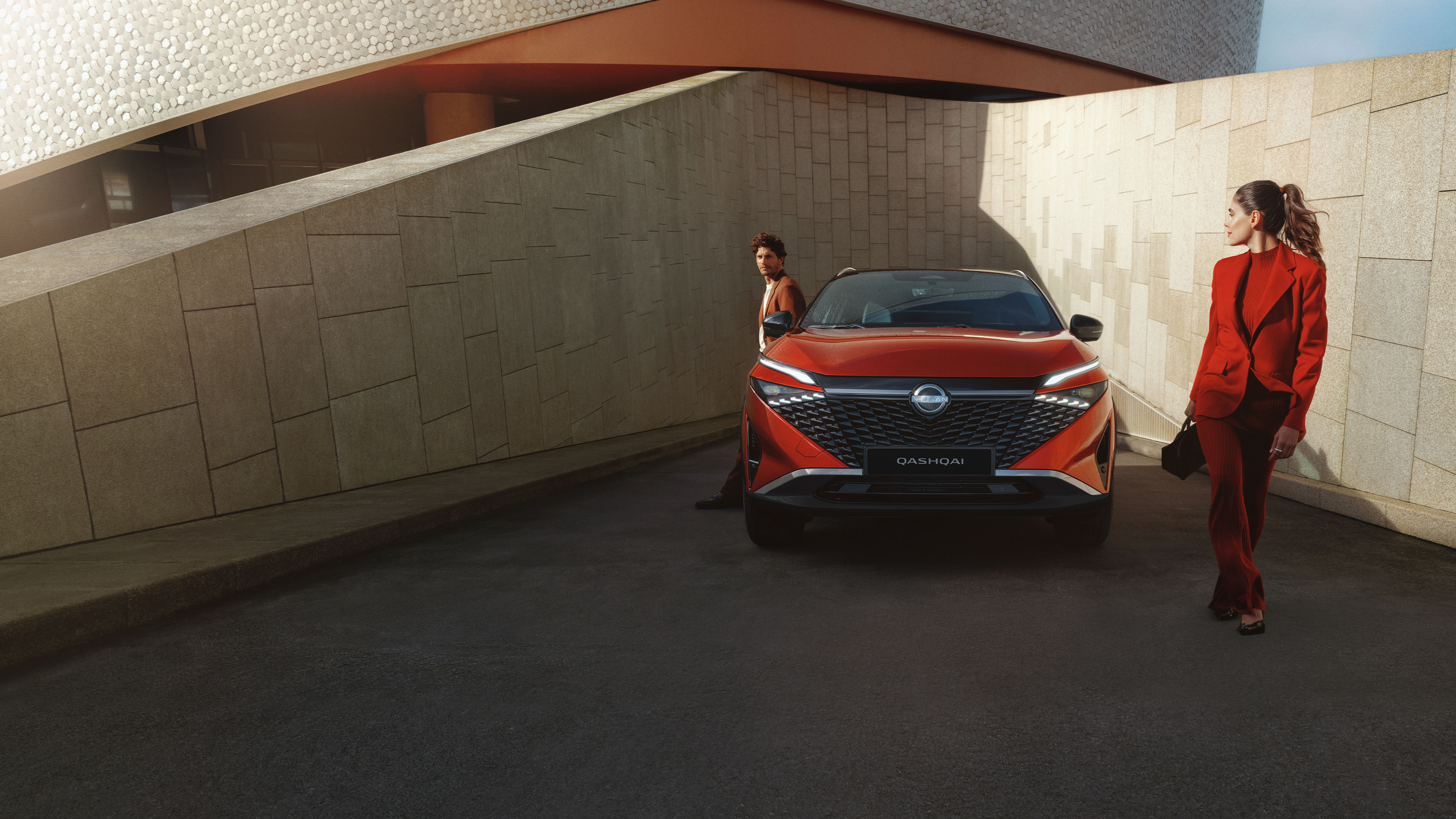 Nissan Qashqai e-Power full front static view with man leaning against the bonnet.