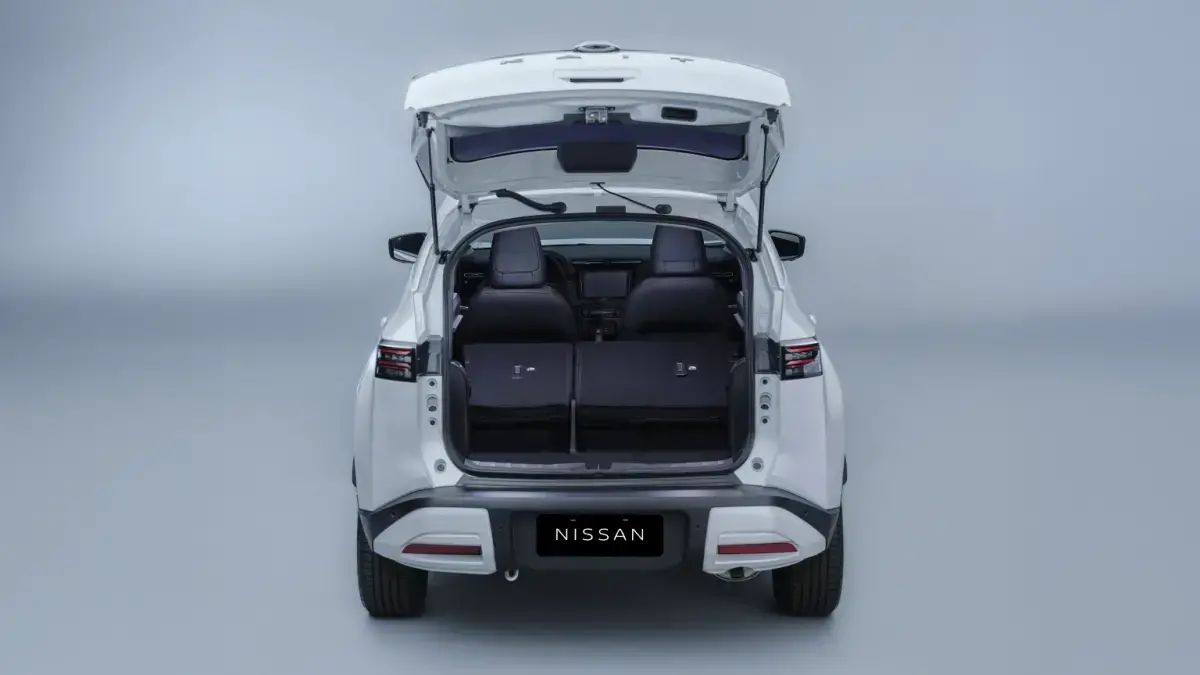 Visão interna da área de carga do Nissan KAIT com os bancos traseiros rebatidos, mostrando o aumento do espaço e versatilidade.
