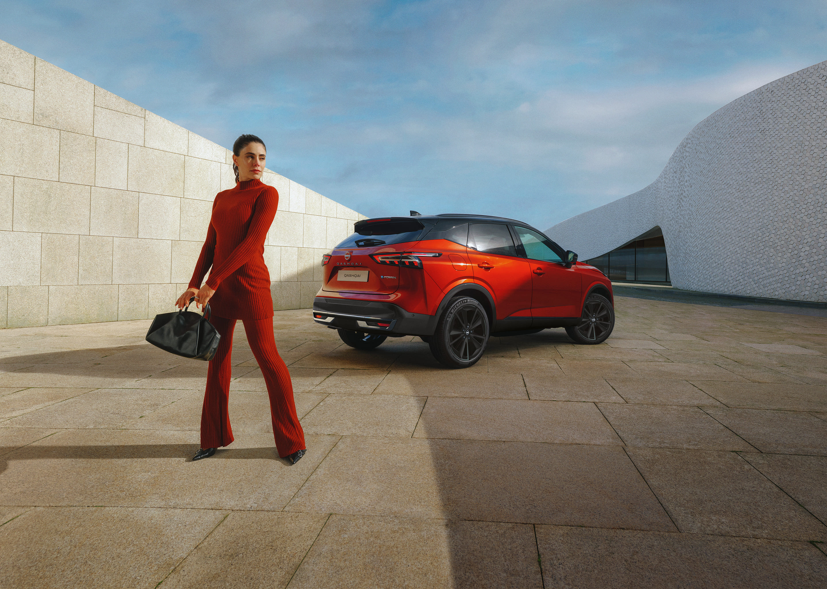 Nissan Qashqai e-Power full front static view with man leaning against the bonnet.