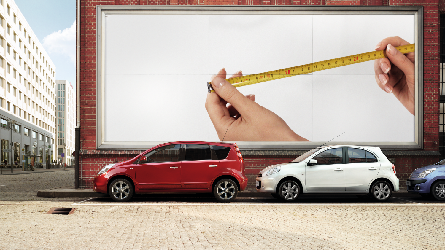 Driver side profile parked in front of billboard