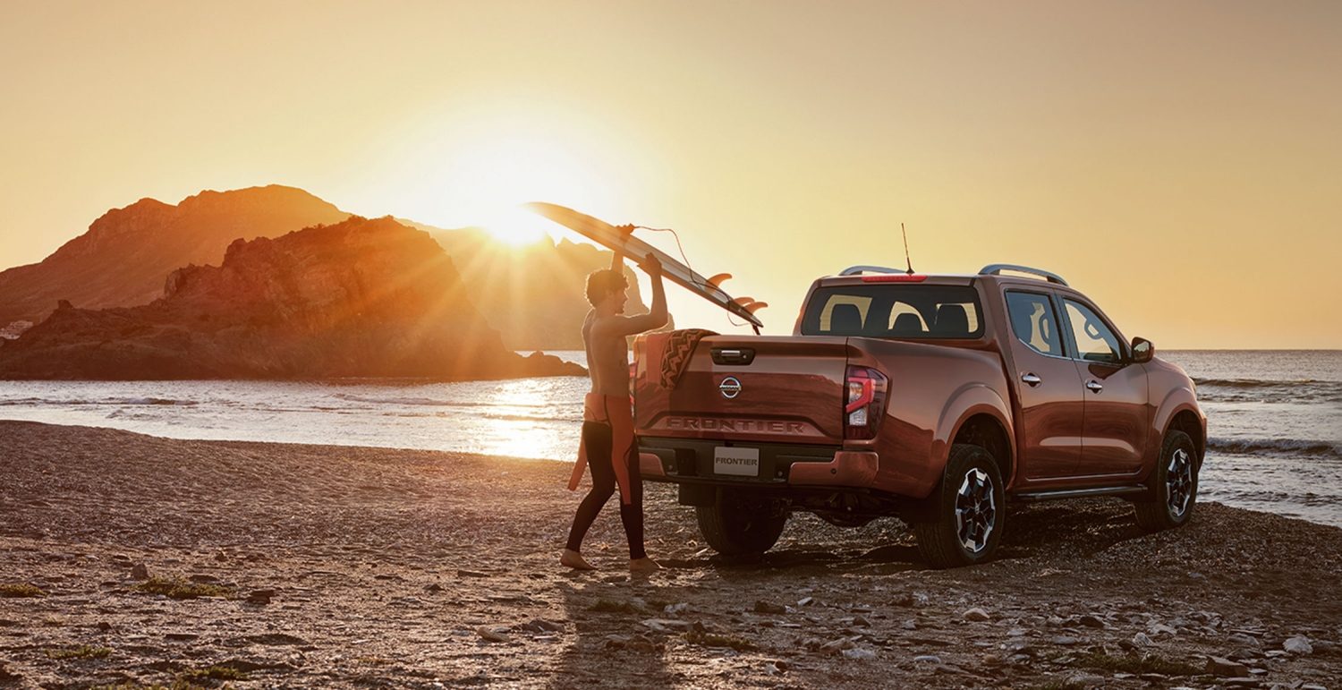 2021 Nissan Frontier on mountain road with 2 motorcycles in the truck bed