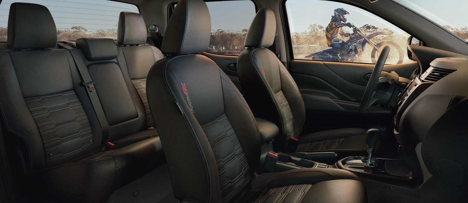 2021 Nissan Frontier PRO-4X interior showing front and rear seats with special badging