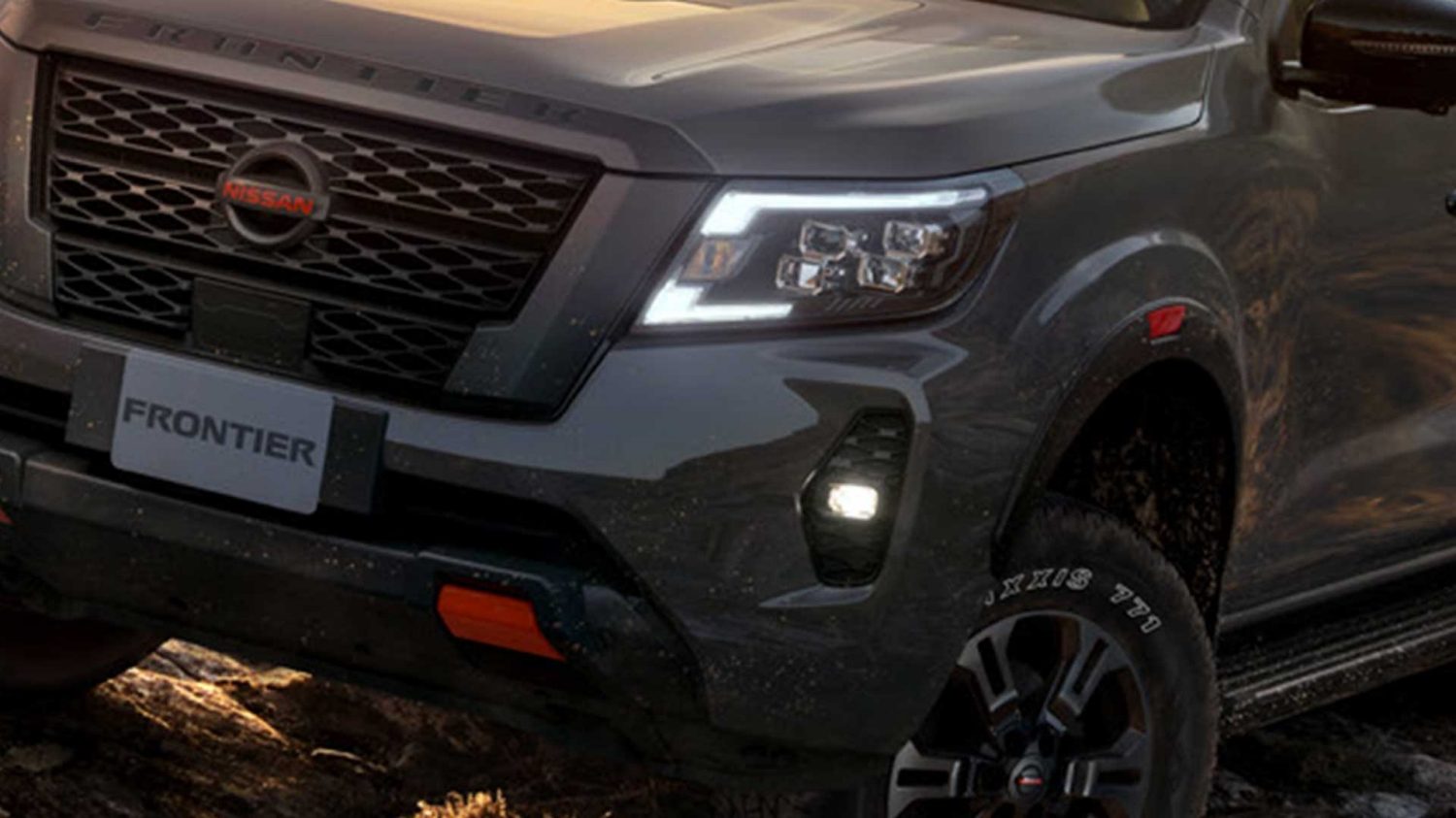 2021 Nissan Frontier PRO-4X towing trailer around large boulders